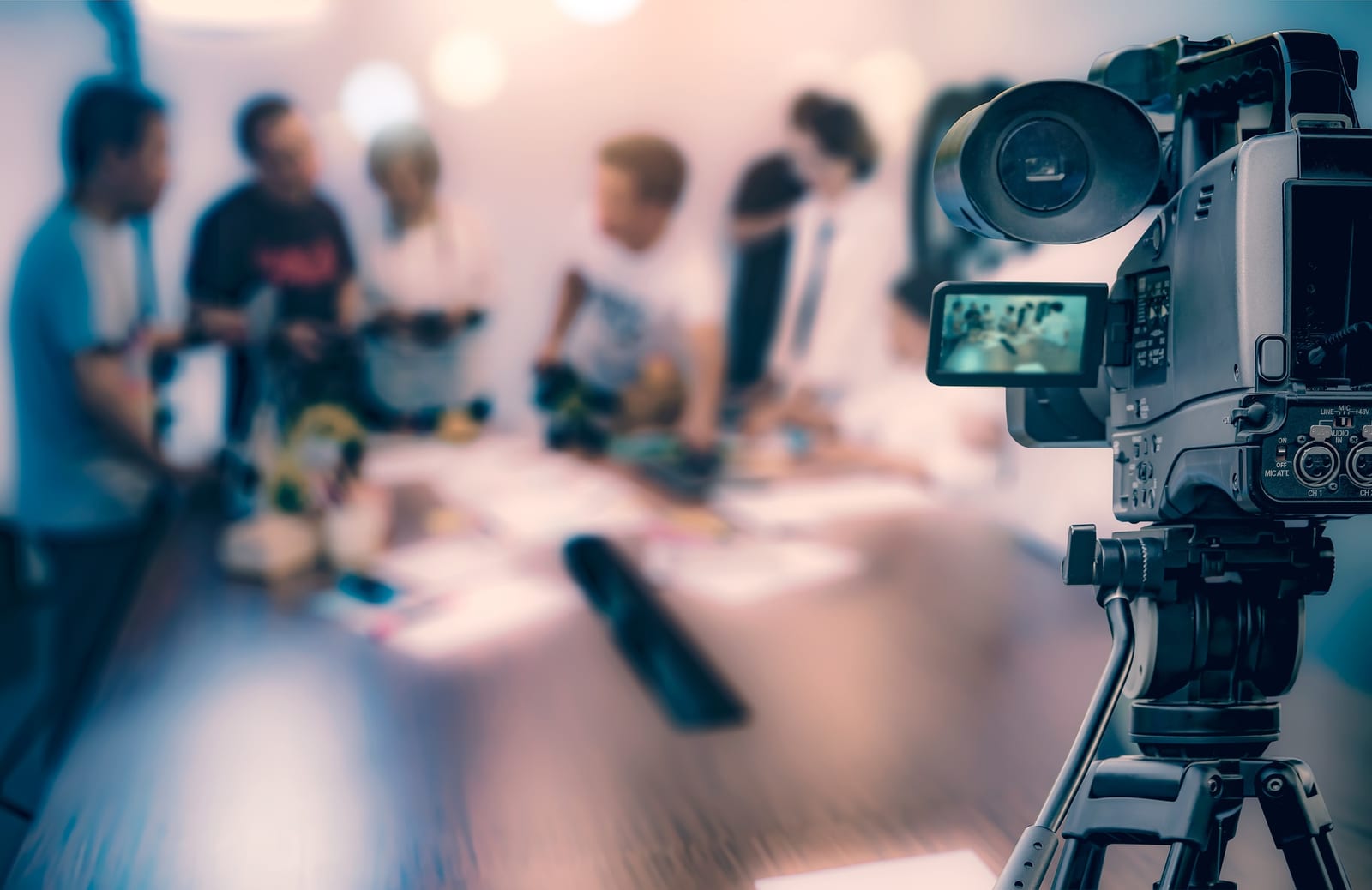 Reporter reviewing notes with a video camera set up for a live segment